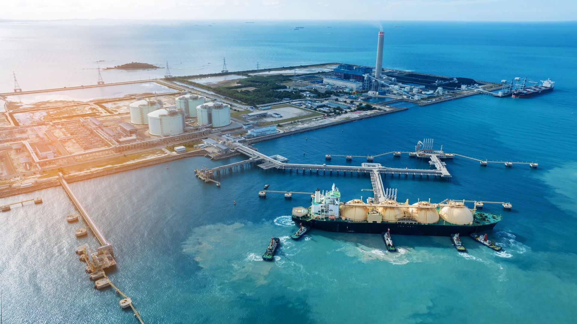 LNG (Liquefied natural gas) tanker anchored in Gas terminal gas tanks for storage. Oil Crude Gas Tanker Ship. LPG at Tanker Bay Petroleum Chemical or Methane freighter export import transportation